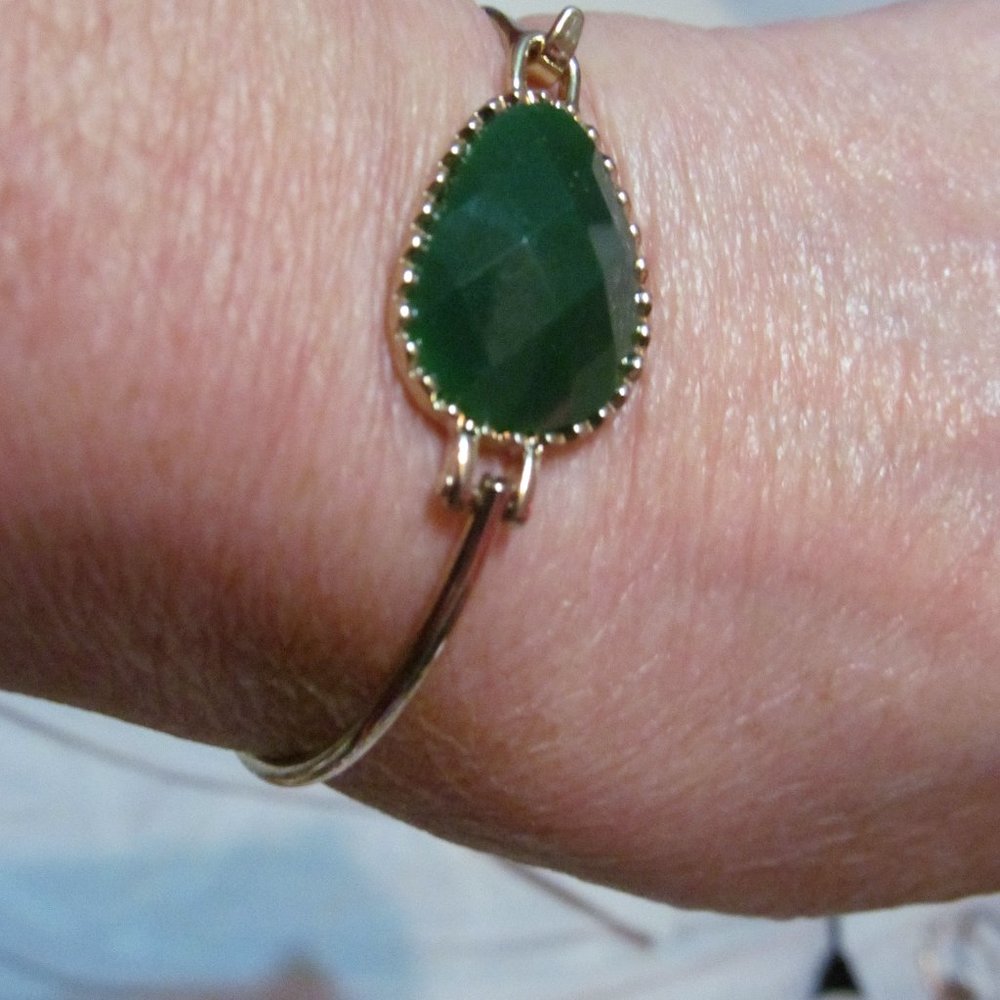Gold tone clip on bracelet green faceted cabochon